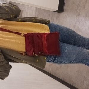 A red over the shoulder purse with adjustable strap